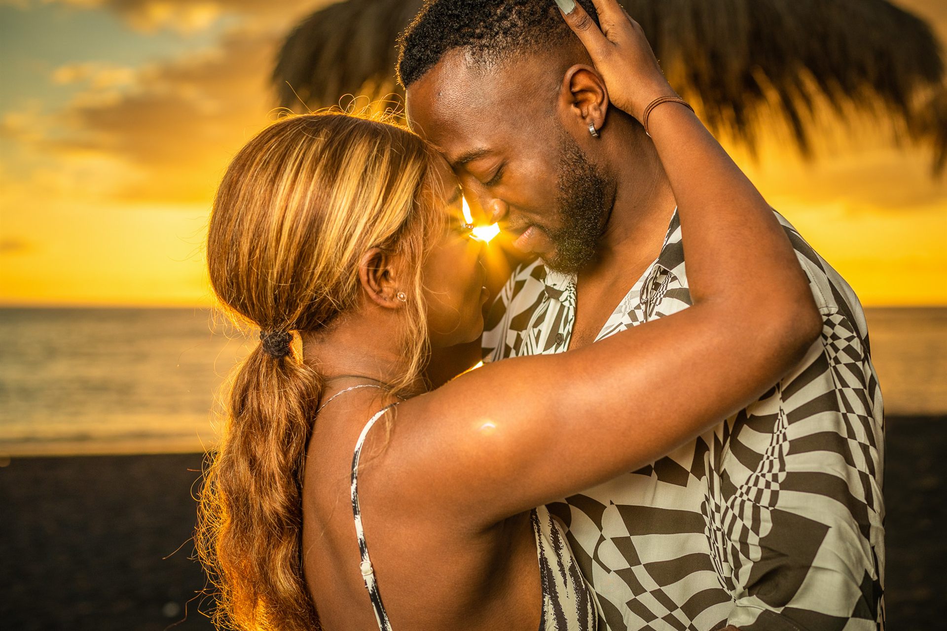 Couple embracing at golden hour on Playa del Duque