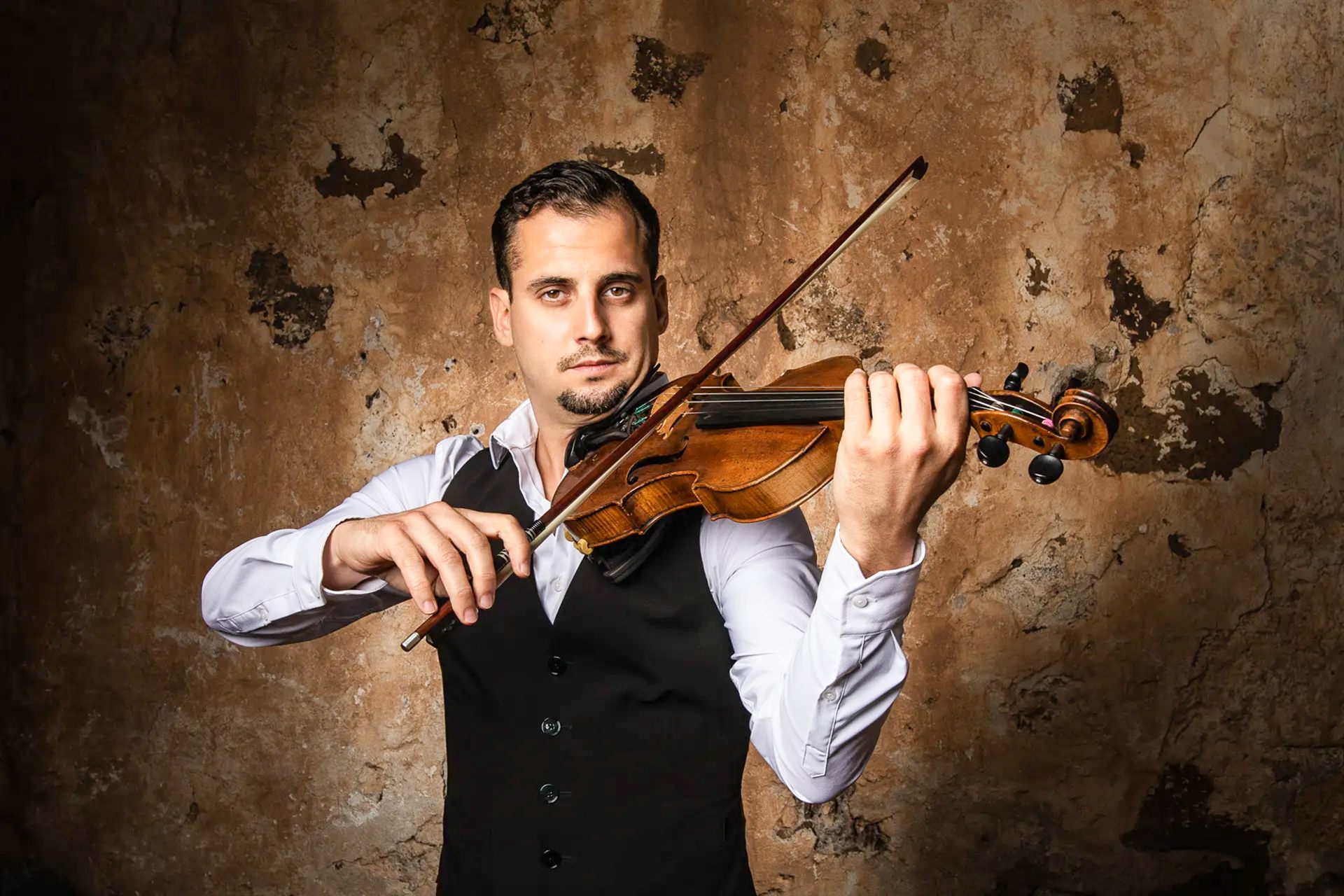 Cinematic editorial portrait of a violin virtuoso in Las Chafiras