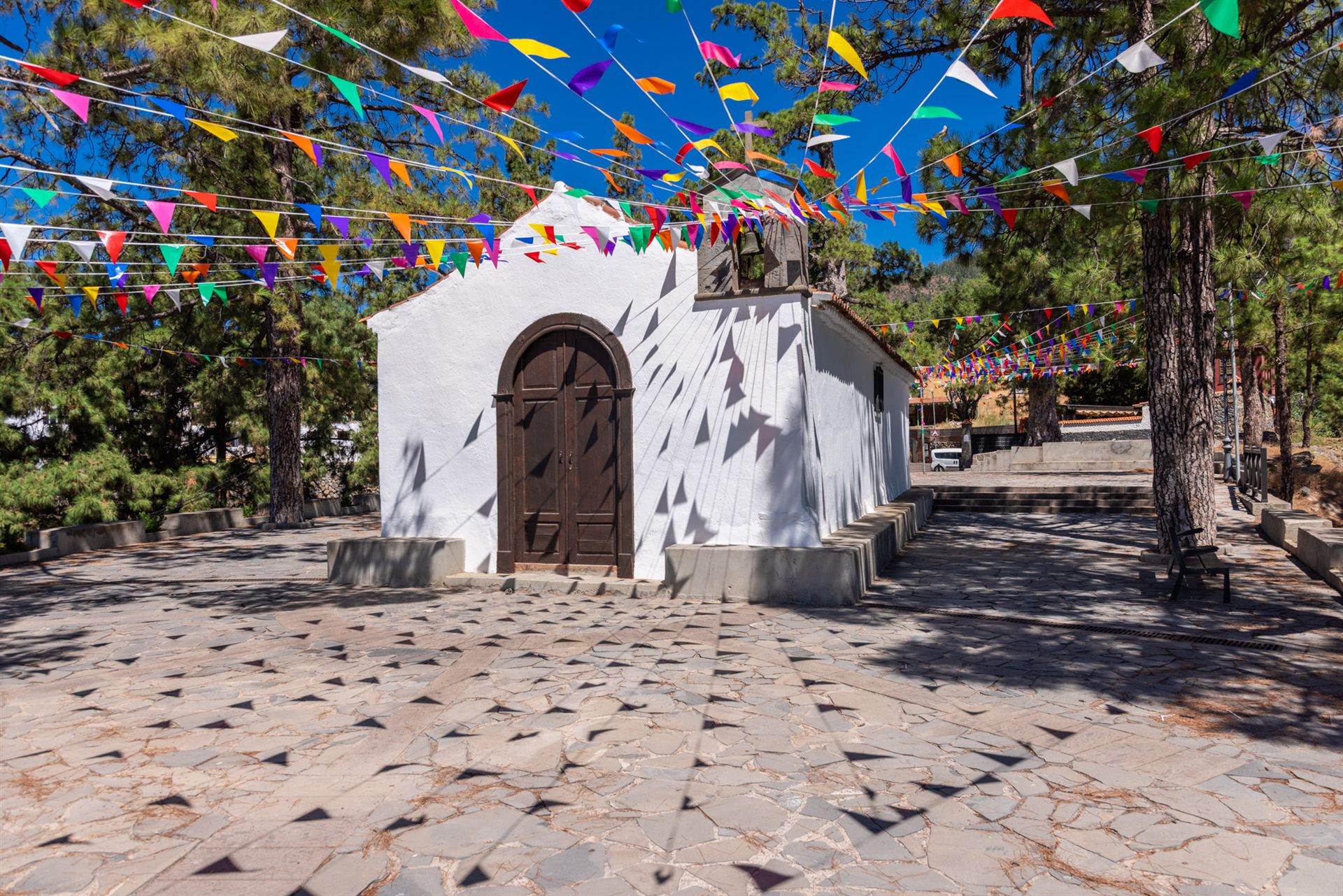 Vilaflor's little white chapel decorated with colorful bunting for the patron saint festival